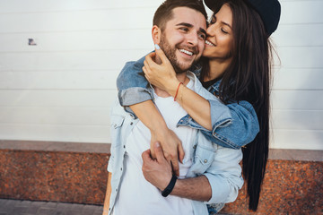 Young beautiful girl hugging her handsome boyfriend