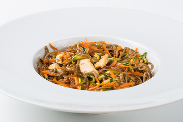 White plate of asian noodles with vegetables