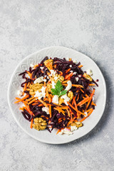 Raw beeroot carrot goat cheese cilantro olive oil dressing.Top view, space for text.