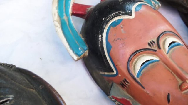 African wooden masks. They lie on the table. Masks are very old.