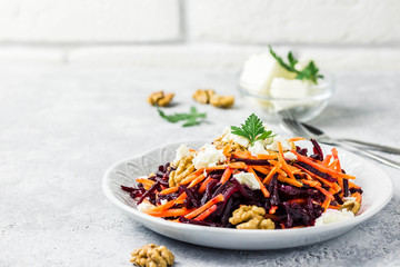 Carrot Beetroot feta cheese walnuts salad grapefruit olive oil dressing. Selective focus, space for text.