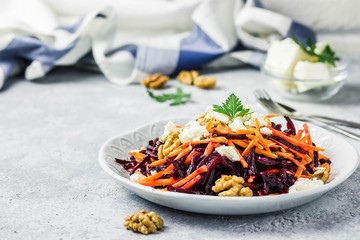 Carrot Beetroot feta cheese walnuts salad grapefruit olive oil dressing. Selective focus, space for text.