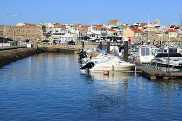Fototapeta na wymiar Peniche marina with blue water in the foreground and boats in the background