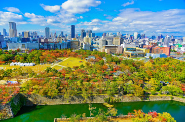 Fototapeta premium View of the Osaka Castle Park in autumn and city center in the background in Osaka, Japan.