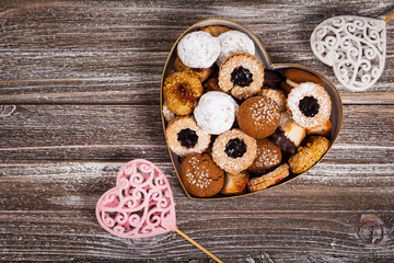 Valentines Day Card Background with Assorted Cookies over Wooden Background. Selective focus.