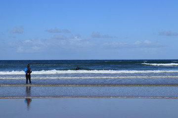 Fototapeta na wymiar surf instructor giving directions to his student on the beach of Gamboa in Peniche