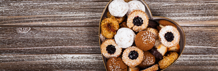Valentines Day Card Background with Assorted Cookies over Wooden Background. Selective focus.