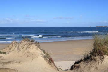 view over the dunes to the blue waters beach, Gâmboa beach