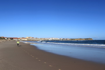 woman jogging in the sand on the beach