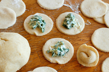 Making ravioli with ricotta cheese and spinach