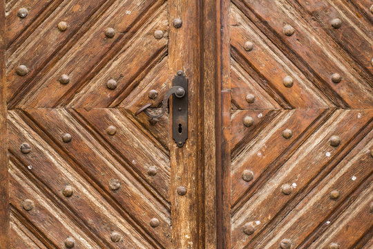 Close up of old vintage wooden door with metal furniture