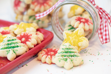 Obraz premium Christmas photograph of homemade Spritz cookies flowing out of a Mason jar