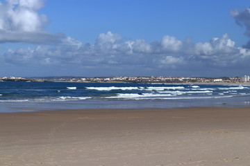 Fototapeta na wymiar brown sand, dark blue sea with sky background
