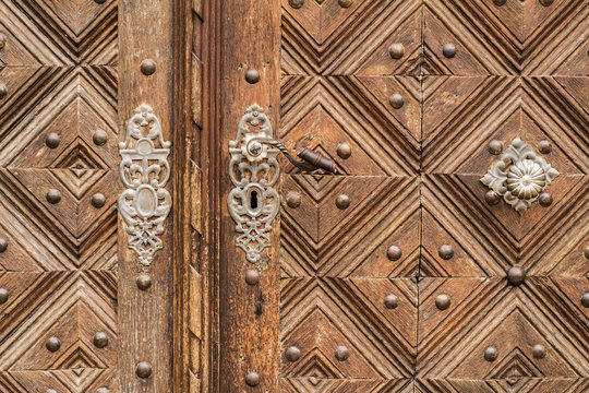 Close up of old vintage wooden door with metal furniture