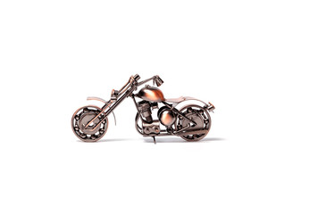 Handmade model of custom motorcycle bike. Copper scale model of chopper. Side view. Isolated on white.