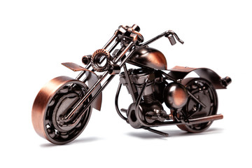 Fototapeta na wymiar Handmade model of custom motorcycle bike. Copper scale model of chopper. Side view. Isolated on white.