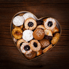 Valentines Day Card Background with Assorted Cookies over Wooden Background. Selective focus.