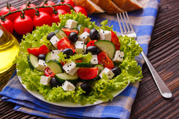 Greek salad on a wooden rustic background