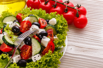 Greek salad on a wooden rustic background