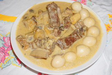 Quail egg with beef ribs creamy sauce traditional Filipino food Asian cuisine steamed beef on white plate 