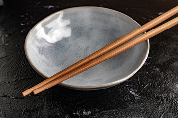 Empty bowl with chopsticks to eat.
