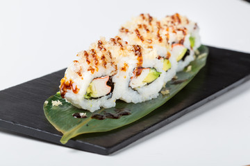 Set of uramaki sushi rolls with sauce topping