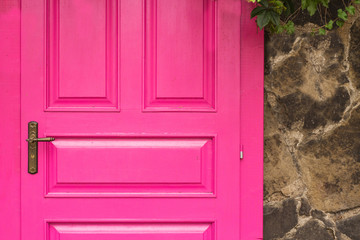 vintage wooden pink door with metal furniture