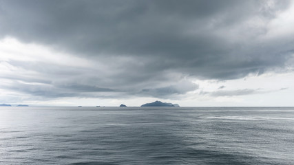 Sea and island with dark rain clouds in rainy season