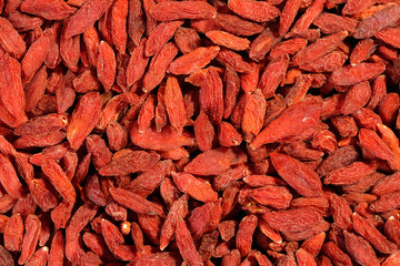 Extreme close up of dried organic goji berry fruits (wolfberries). Macro texture food background