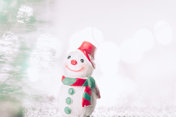 A miniature  Snowman on Christmas background.Xmas greeting card with copy space.