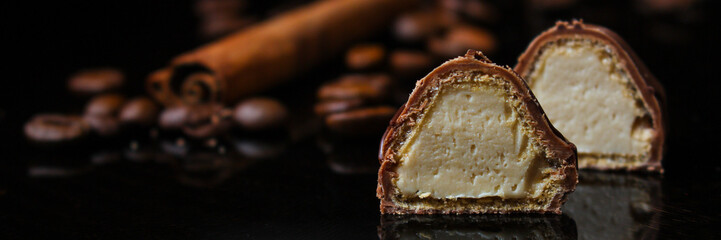 candy, chocolate, filler, cream, coffee  (Black background). food background. copy space