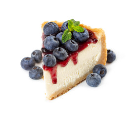 Piece of cheesecake with blueberries and mint