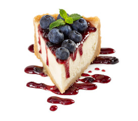 Piece of cheesecake with blueberries and mint