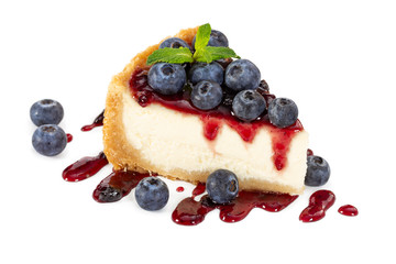 Piece of cheesecake with blueberries and mint