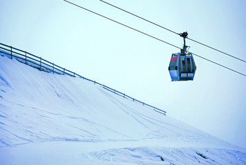 Fototapeta na wymiar Cable car in a ski resort going up. Winter season
