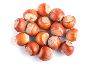 Pile of hazelnuts with shell isolated on white background.