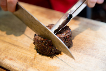 Chopping the beefsteak on Wooden Cutting Board