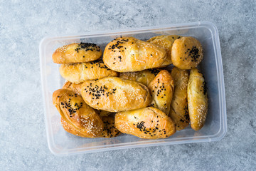 Homemade Turkish Pastry Pogaca with Cumin Seeds / Black Sesame and Cheese in Plastic Box / Container or Package.