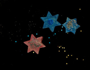 Pink and blue stars with black background
