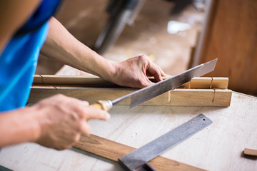 The hand of a craftsman is working with a dangerous tool.