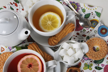 various cookies and biscuits baked at home in a container and tea in a retro cup with free space for text