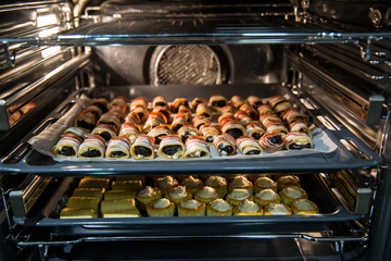 baking in oven, rolled bacon and pastry with cheese