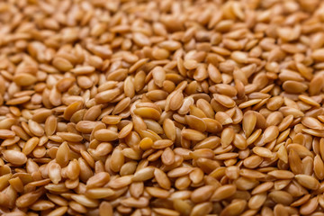 Seeds of golden flax on a white background