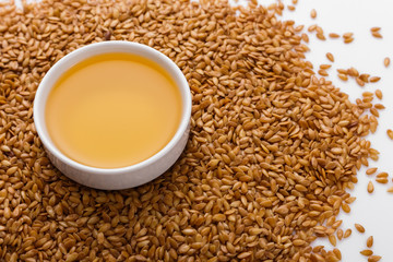 Seeds of golden flax on a white background