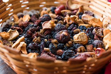 Mix of Dried Fruits; Apple, Apricot, Mulberry, Raisin, Fig, Cranberry, Raspberry and Date in Wooden Basket.