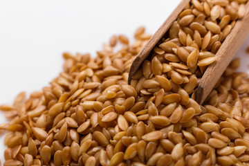 Seeds of golden flax on a white background