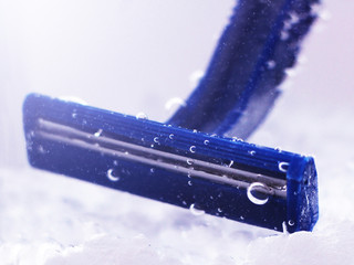 blue disposable razor in water with bubbles