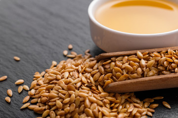 seeds of golden flax on a dark stone background