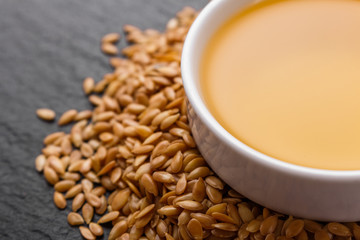 seeds of golden flax on a dark stone background