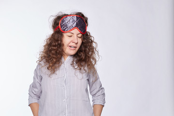  Portrait of sleepy young woman with wide open mouth yawning, eyes closed, looking swelling from too much drinking in evening, has hangover, isolated on white. Face expression, body language concept.